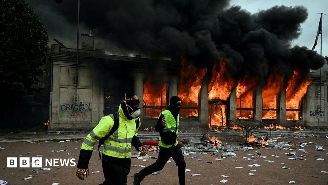 Flames consuming a storefront on a Paris street during the June 2024 cost‑of‑living protests