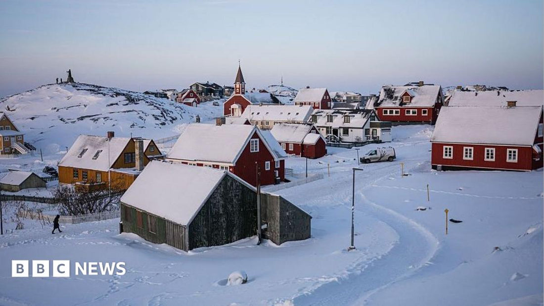 Aerial view of Greenland's icy coastline with a US flag planted near a construction site for a new military base.