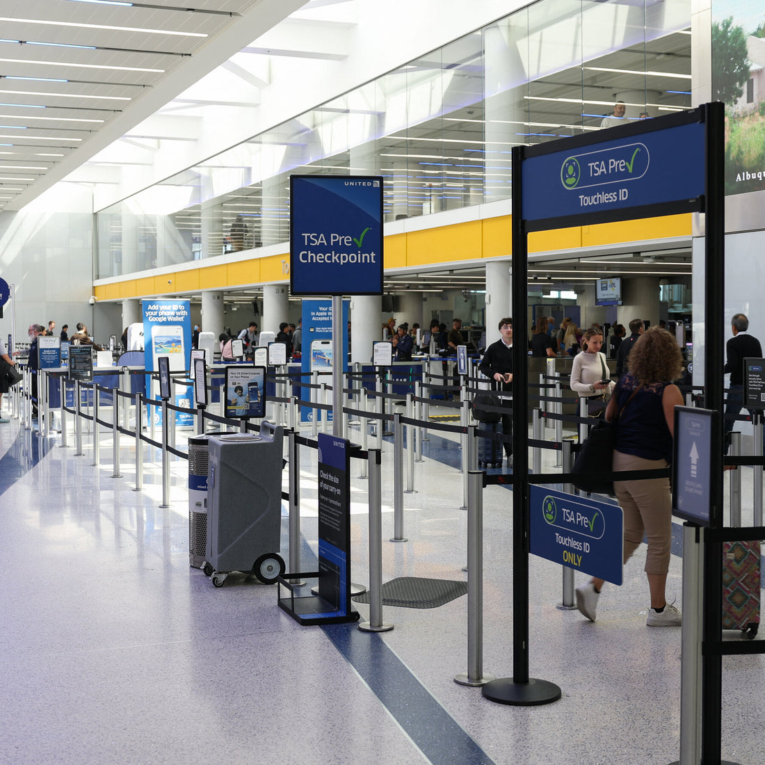 TSA PreCheck member showing credential badge at an airport security checkpoint