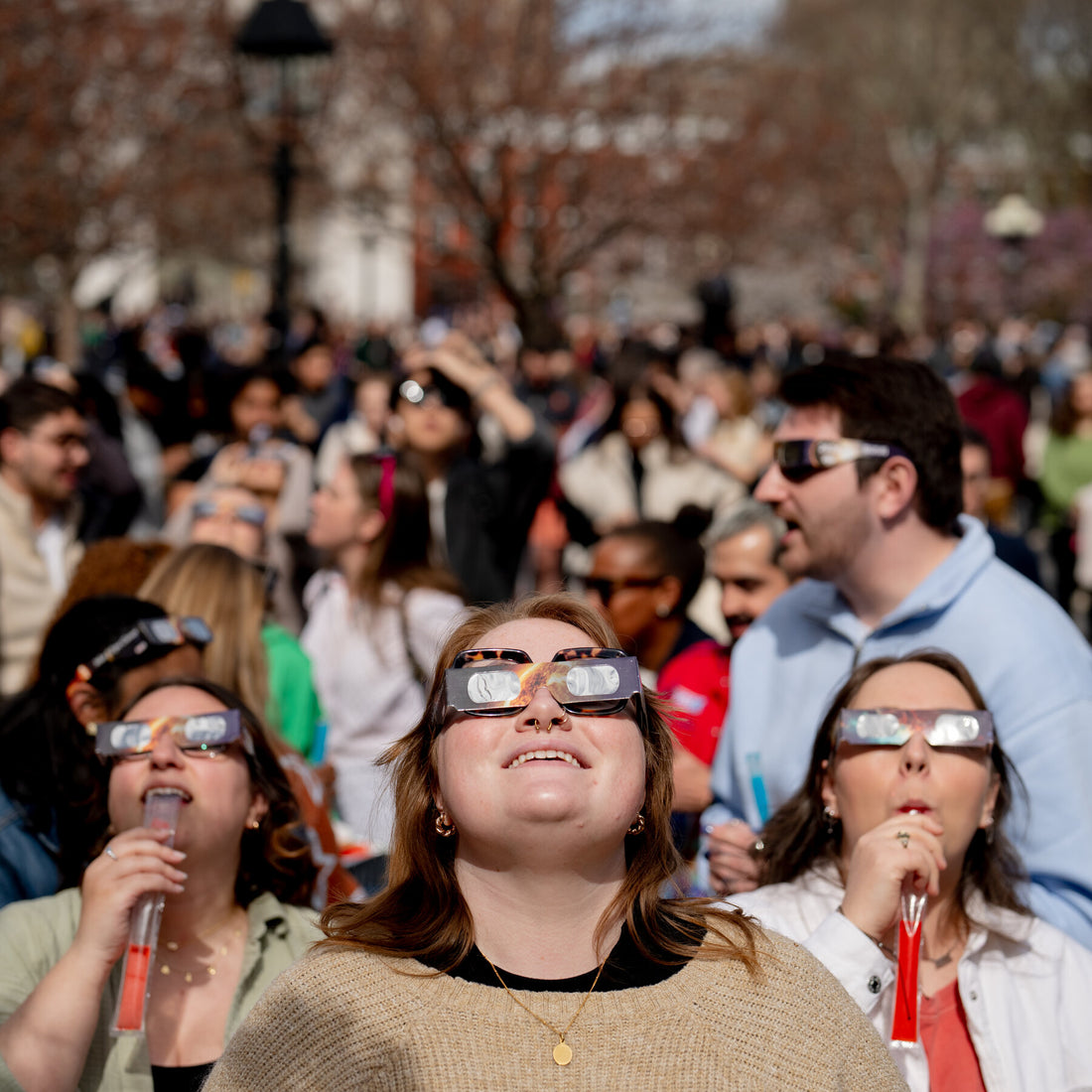 People wearing solar eclipse glasses
