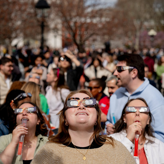 People wearing solar eclipse glasses