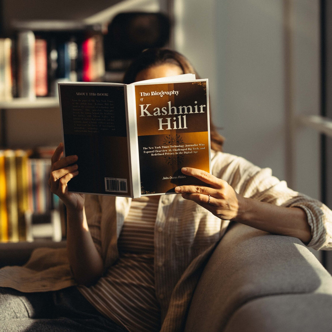 A person looking at a book with a surprised expression