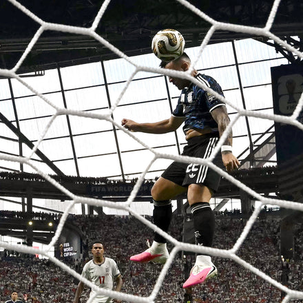 A soccer player scoring a goal