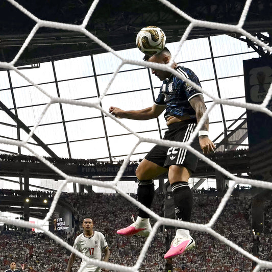 A soccer player scoring a goal