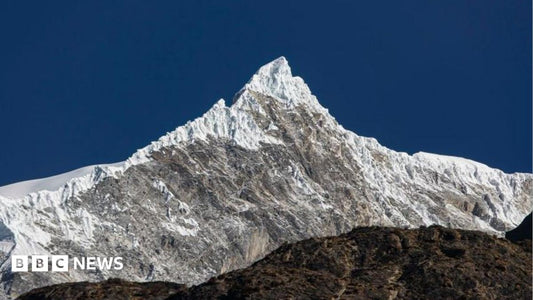 Aerial view of a Himalayan glacier showing crevasses and meltwater streams