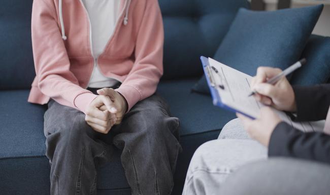 A child speaking with a mental health professional