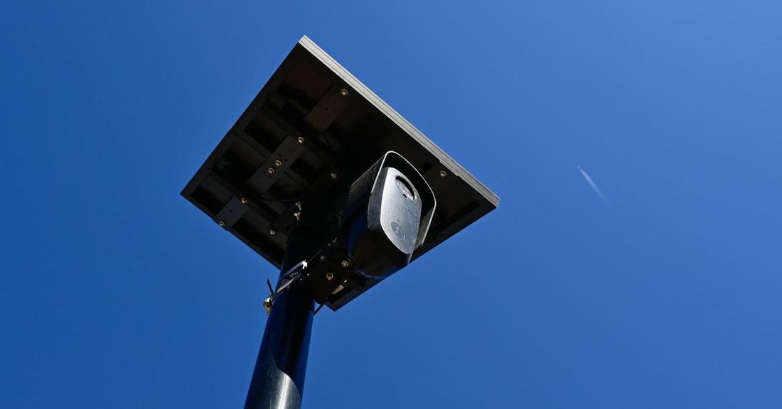 A city traffic camera mounted on a street pole capturing vehicle license plates at night
