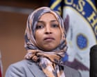 Federal agents standing outside Ilhan Omar's residence with a warrant document visible