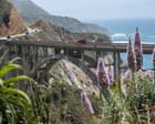 Aerial view of Big Sur coastline with smoke from wildfire drifting over redwood forest