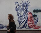 Donald Trump speaking at a press conference with a backdrop of the US flag, illustrating his public statements on Iran.