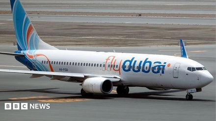 Cabin crew securing a passenger after a violent incident on a commercial flight