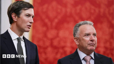 Jared Kushner and Steve Witkoff standing outside a Kyiv government building during their first visit.