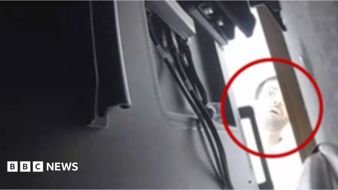 Close‑up image of a miniature audio recording bug hidden inside a power adapter