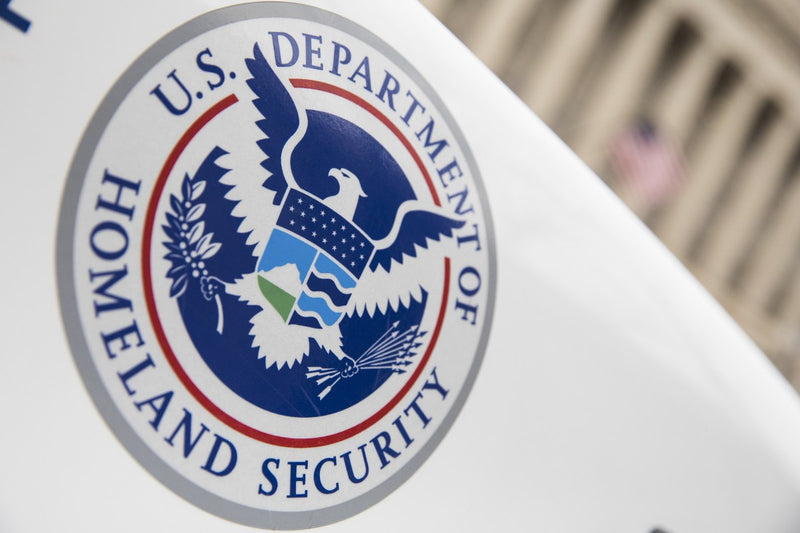 Screenshot of a Bluesky post showing a blocked link warning to a DHS employee data repository