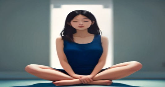 Person seated cross‑legged, eyes closed, practicing mindfulness meditation in a calm indoor setting