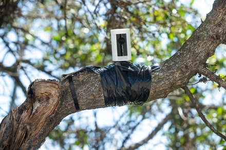 Close-up of a home security camera with a warning overlay indicating potential hacking