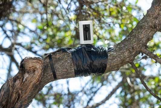 Close-up of a home security camera with a warning overlay indicating potential hacking