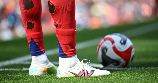 Soccer player cutting holes in socks