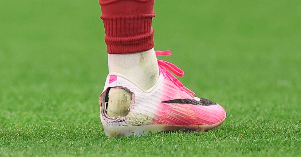 Soccer player wearing modified cleats