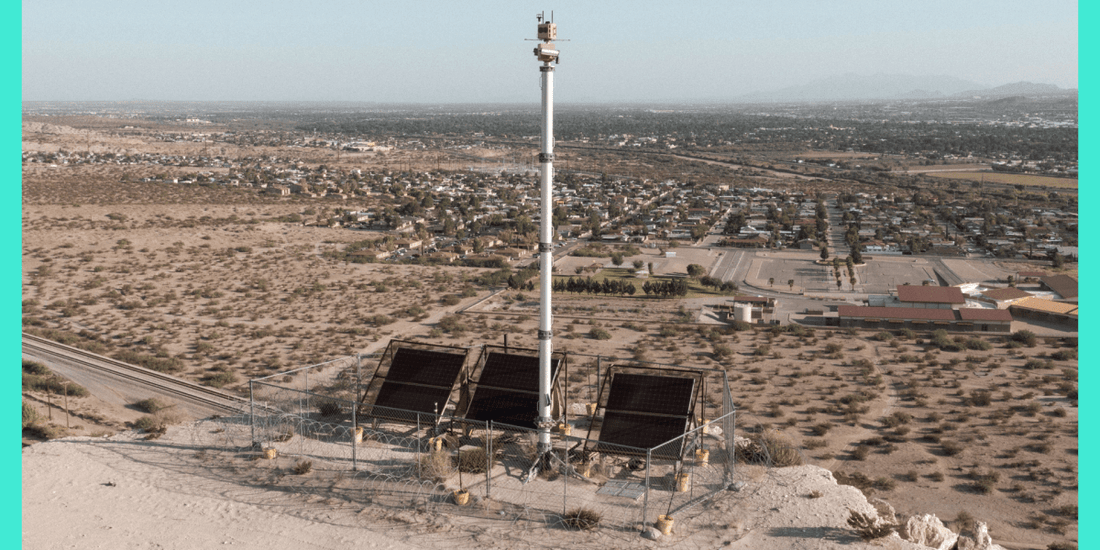A night‑time view of a US border surveillance tower with infrared cameras pointed toward the desert