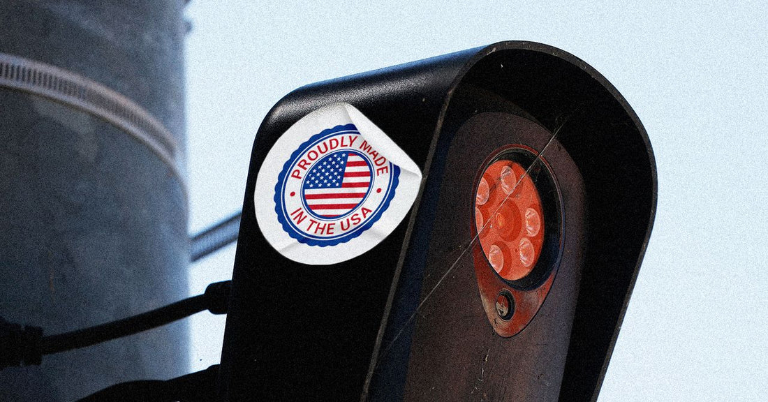 Close-up of a license‑plate reader camera mounted on a street pole, highlighting its housing and mounting hardware.