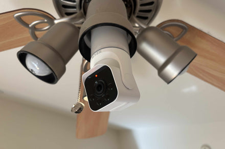 LED light bulb housing a Wi‑Fi security camera mounted in a ceiling fixture, showing its discreet design.