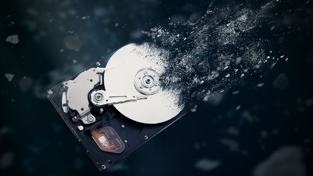 Close-up view of a mechanical hard drive platter showing magnetic data tracks before destruction
