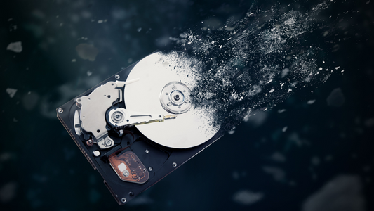 Close-up view of a mechanical hard drive platter showing magnetic data tracks before destruction