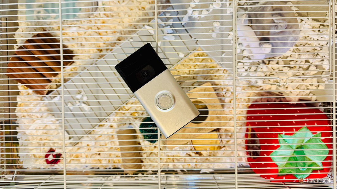 A repurposed smart doorbell mounted on a hallway wall, showing its camera lens aimed at an interior space.