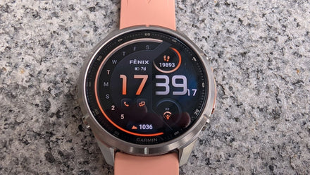 Garmin Fenix 9 Pro on a hiker's wrist against the snowy peaks of the French Alps