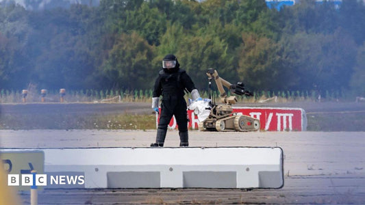A close-up of a small unmanned aerial vehicle (drone) with a visible payload, representing the explosive device found at Leipzig Airport.