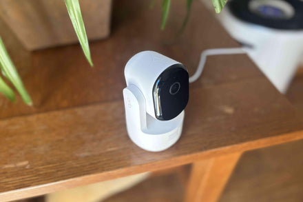 A person installing a home security camera