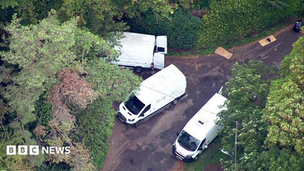 Police vehicles positioned near RAF Fairford following the arrest of five men.