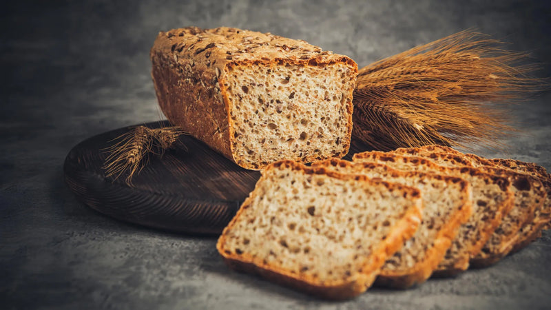 Plate showing four to six standard servings of whole grains including oatmeal, brown rice, and whole-wheat bread
