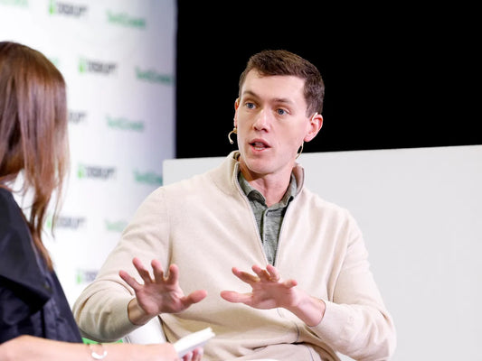 Portrait of Garrett Langley speaking at a press conference about Flock's police contracts