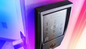 A person installing a smart lock on their front door