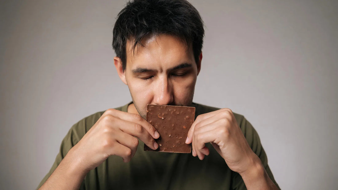 Man inhaling dark chocolate essential oil before performing leg extensions on a gym machine
