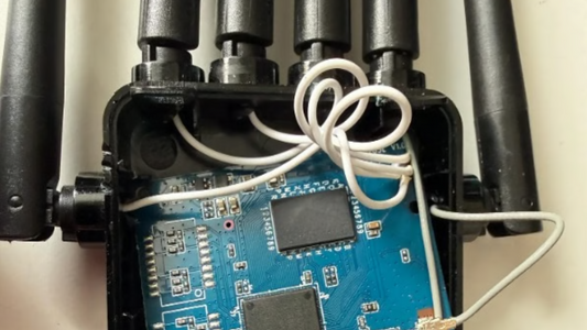 Close-up of a Temu-branded Wi‑Fi extender with visible antenna ports and label indicating £3 price