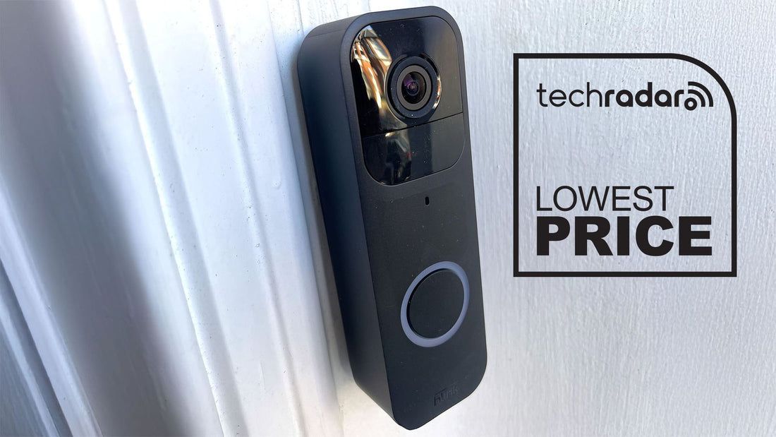 Close-up of Blink Video Doorbell mounted beside a front door, showing its sleek white housing and camera lens.