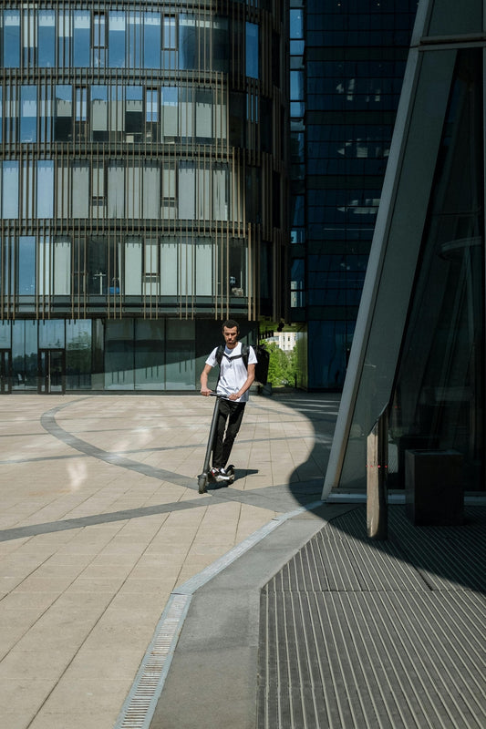 Hover-1 Electric Scooter in urban setting, person riding.