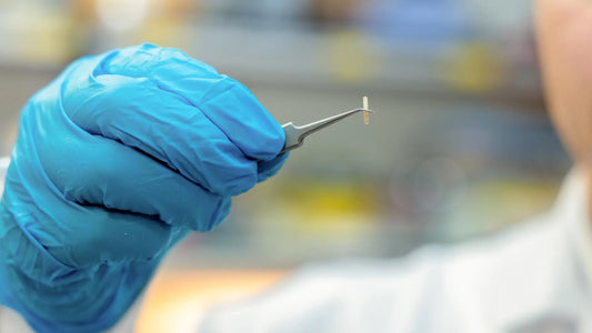 Illustration of a seed-sized implant positioned next to a peripheral nerve under skin