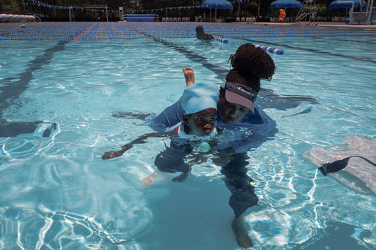 A child with autism in a swimming pool with an instructor
