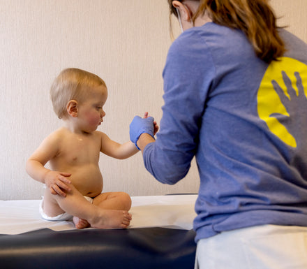 A parent holding a child's hand