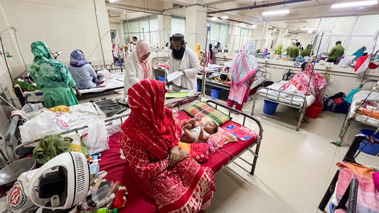 Health workers administering measles vaccine to children in a rural Bangladeshi clinic during the 2024 outbreak